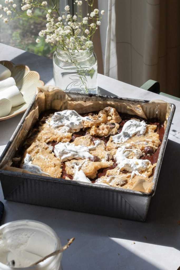 The s'mores brookies layered in a square pan, prior to baking.