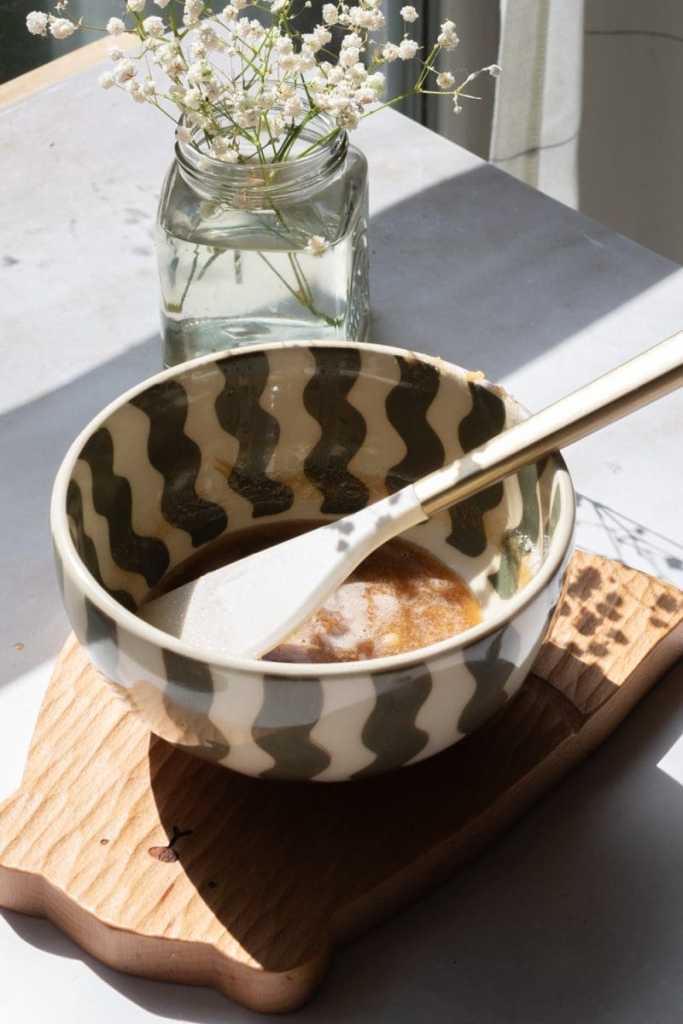 Mixing bowl with the brown butter, sugars, milk and vanilla mixed together.