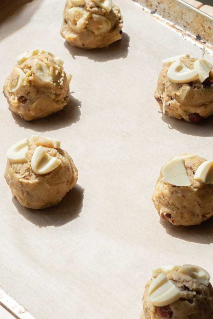 The cookie dough scooped out on a baking tray.