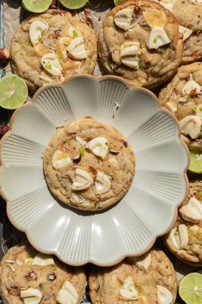 A key lime white chocolate chip cookie on a ruffled plate.