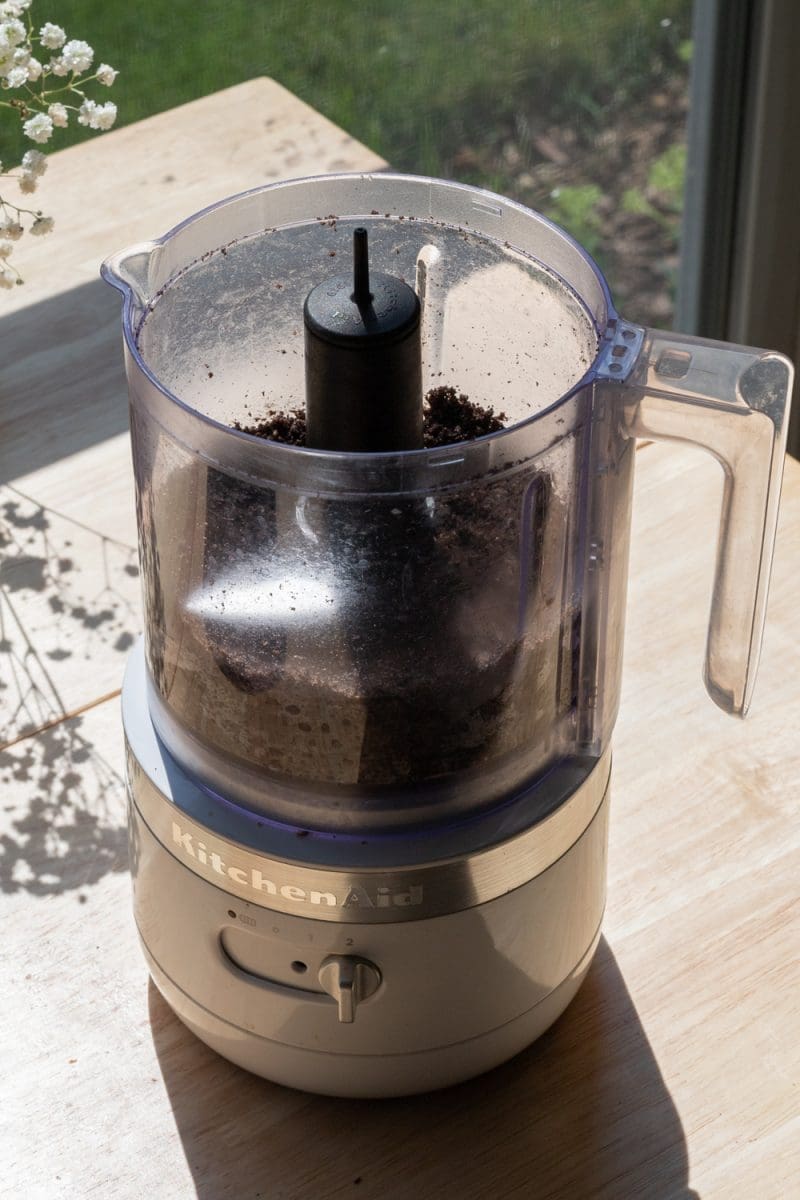 The oreos and butter mixed together in a mini food processor.