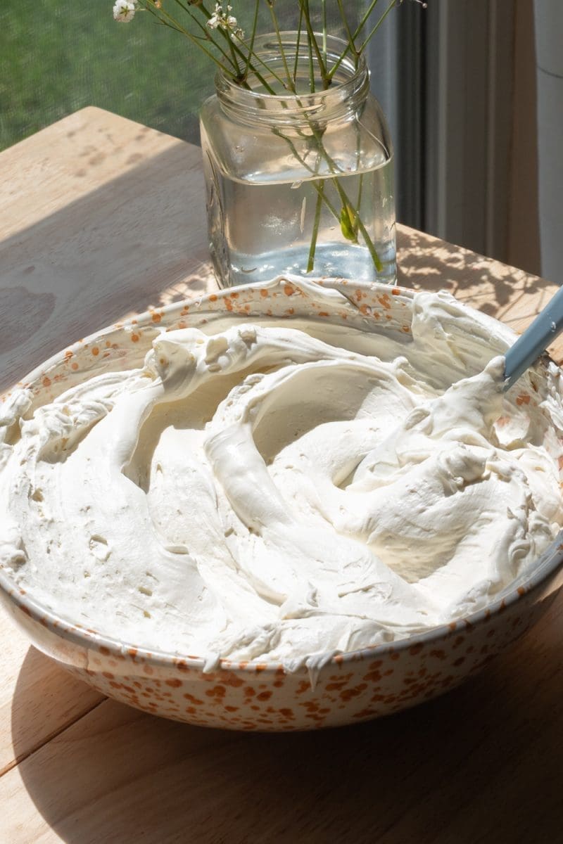 The mascarpone whipped cream in a mixing bowl.