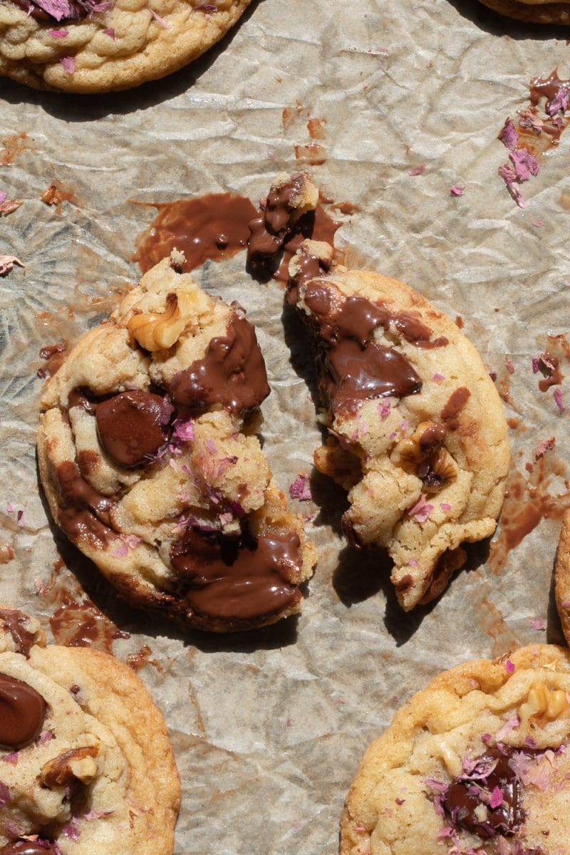 A rose chocolate chip cookie broken in half.