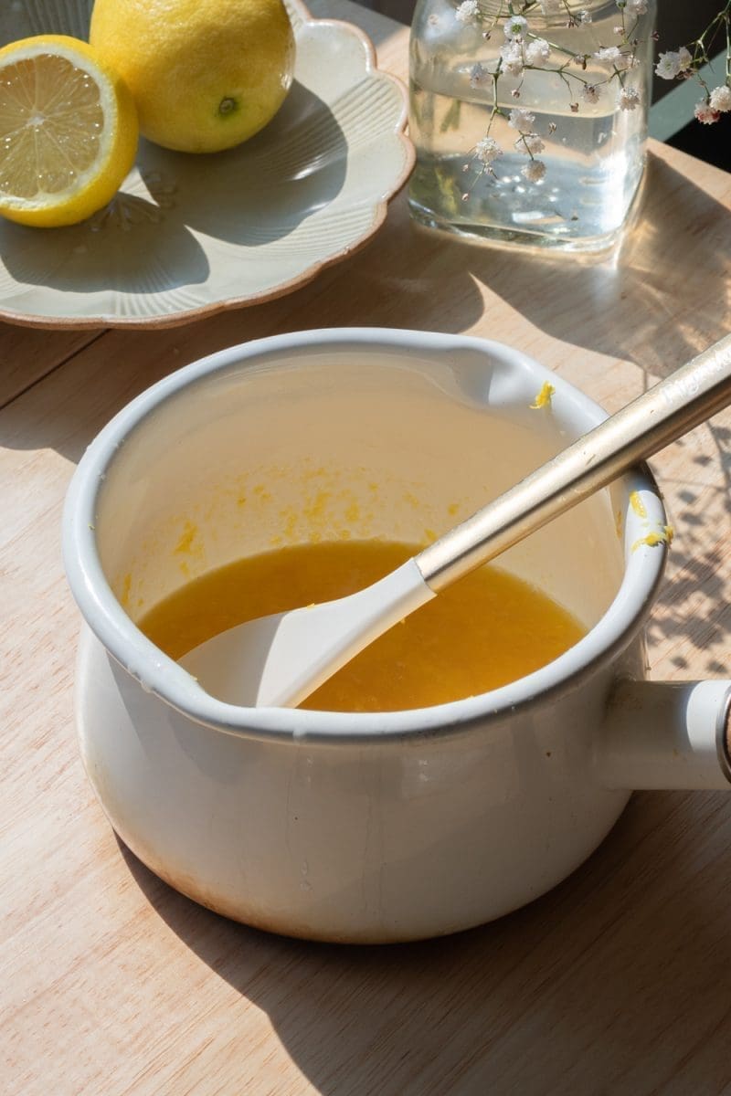 The lemon curd ingredients in a saucepan.