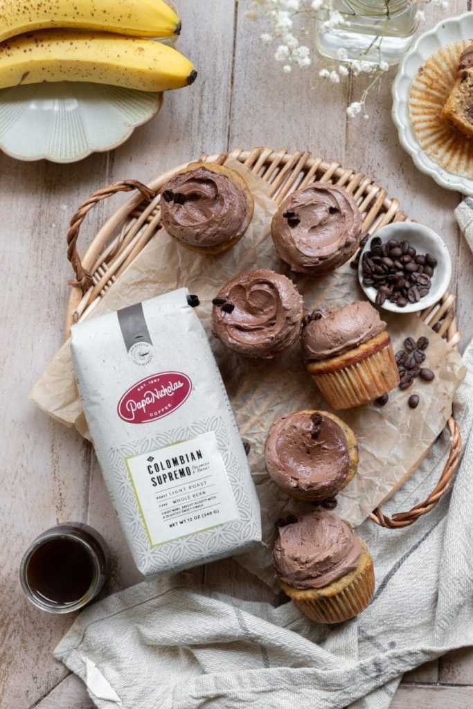The mocha banana cupcakes stylized next to a bag of coffee.