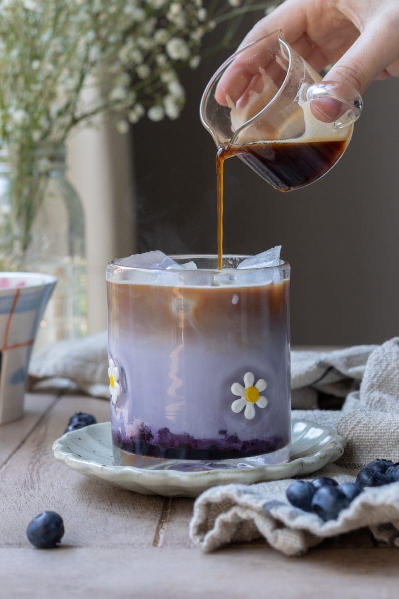 Pouring the espresso over the drink.