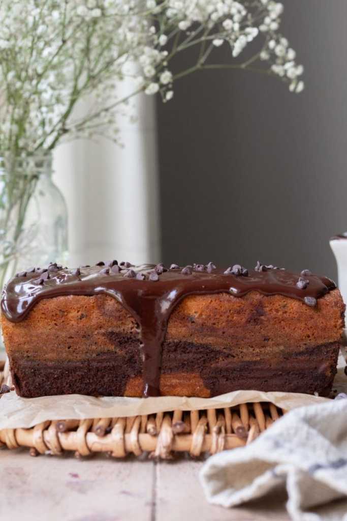 Side view of the whole marbled chocolate chip loaf cake.