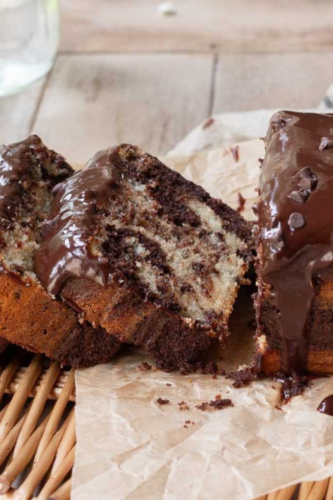 A slice of the marbled chocolate chip loaf cake laying next to the whole loaf.