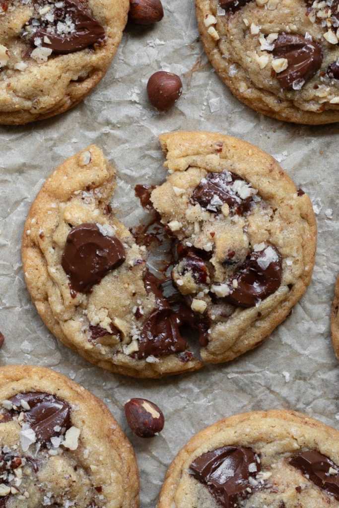 A close up of one of the hazelnut chocolate chip cookies broken in half.