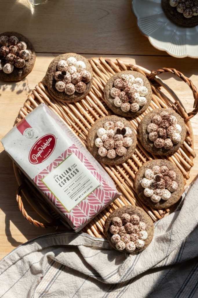 The tiramisu cookies next to a bag of coffee.