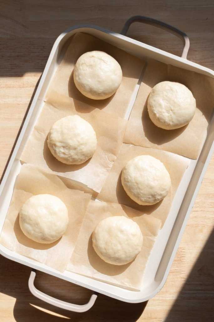 The dough rising on little parchment squares.