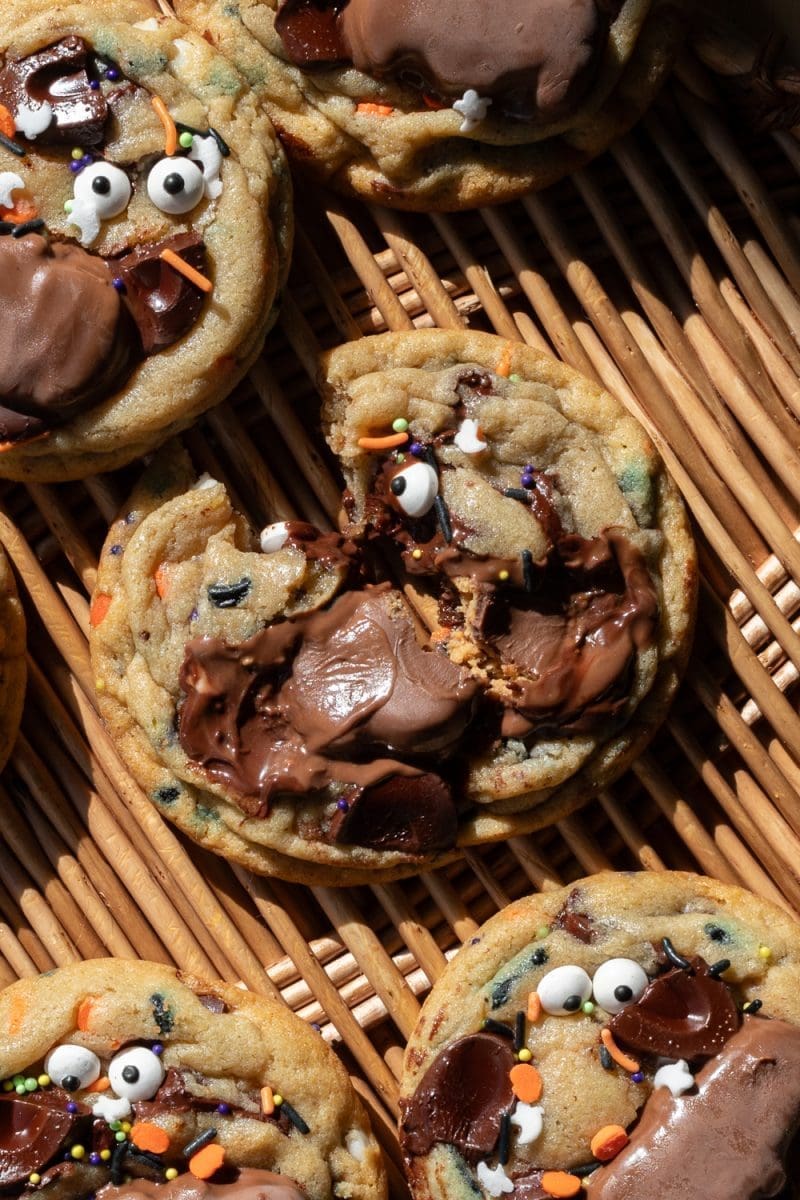 Close up of a halloween chocolate chip cookie broken in half.