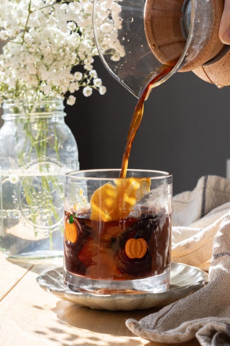 Pouring coffee into the cup.