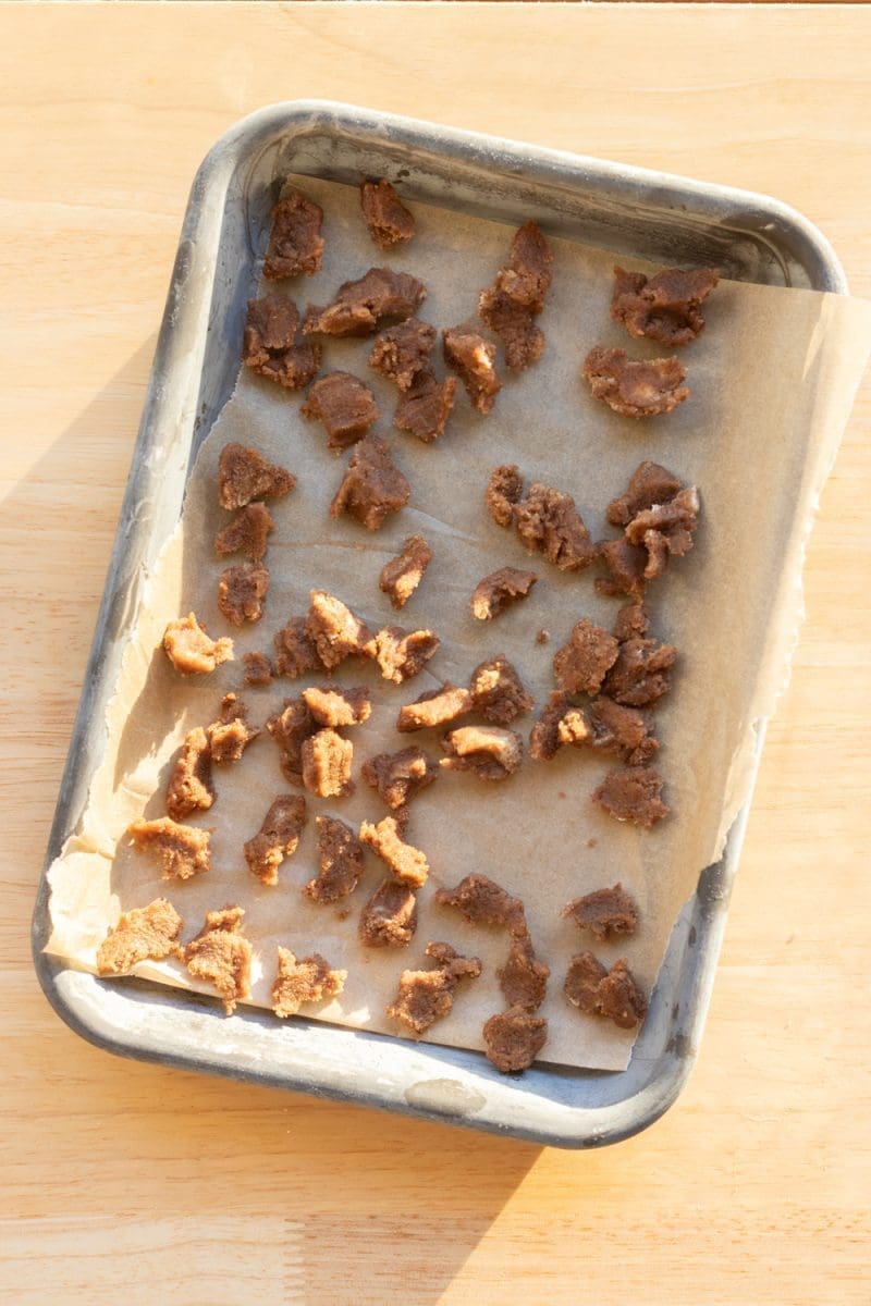 Little cinnamon chips on a baking tray.