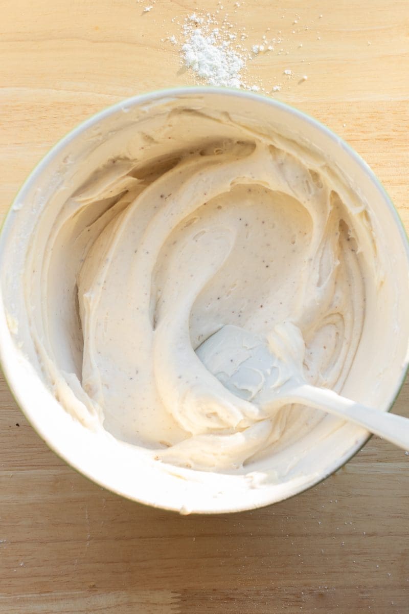 The vanilla bean cream cheese frosting in a mixing bowl.