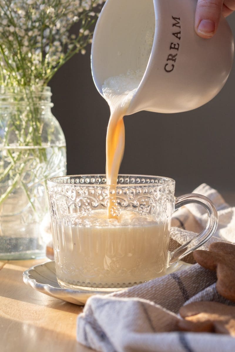 Pouring the eggnog into the cup.