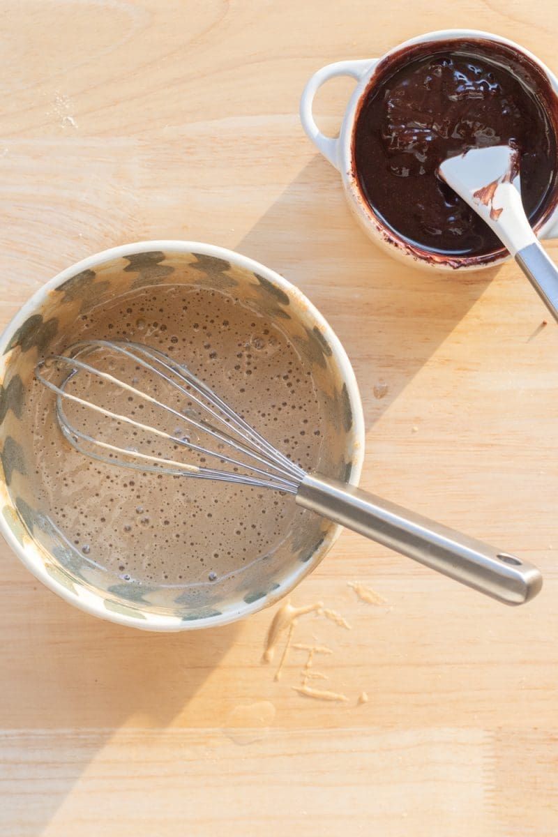 The egg mixture and chocolate mixture in separate bowls.