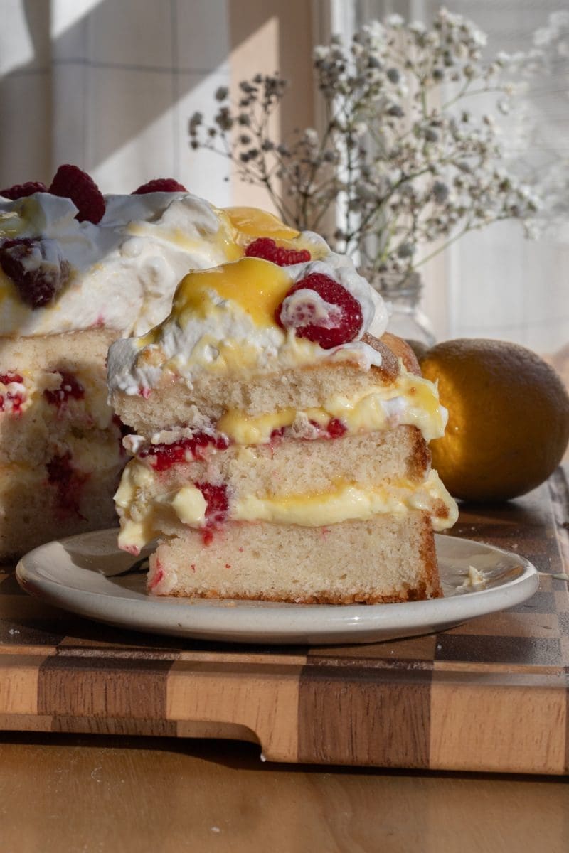 Close up slice of the lemon raspberry vanilla cream cake