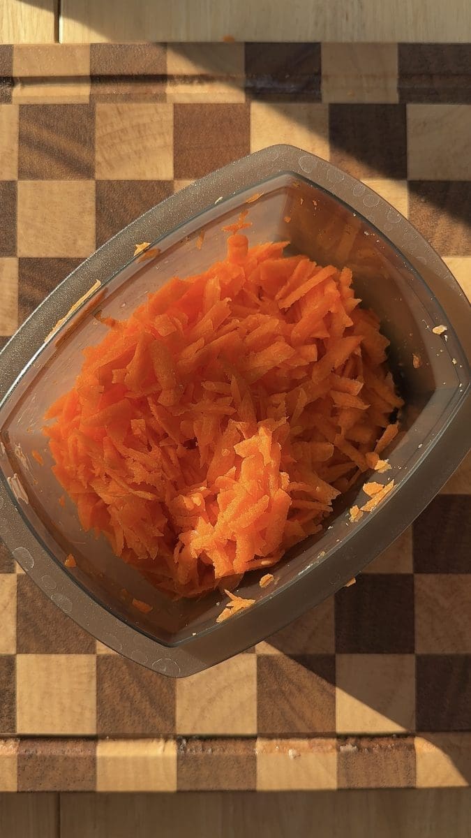 Shredded carrots in a bowl.