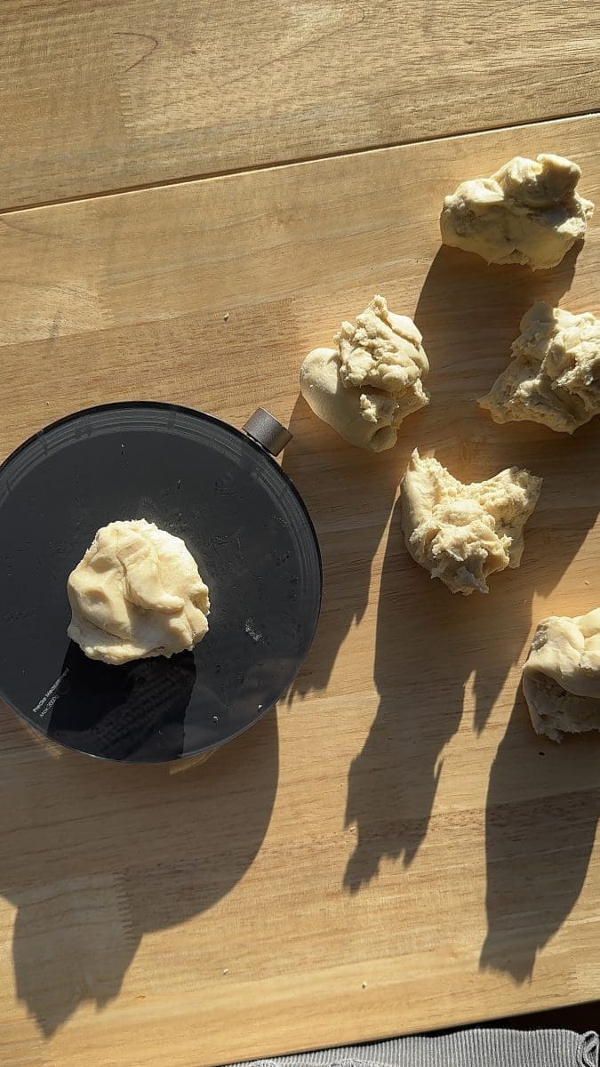 The dough divided into six pieces using a kitchen scale.