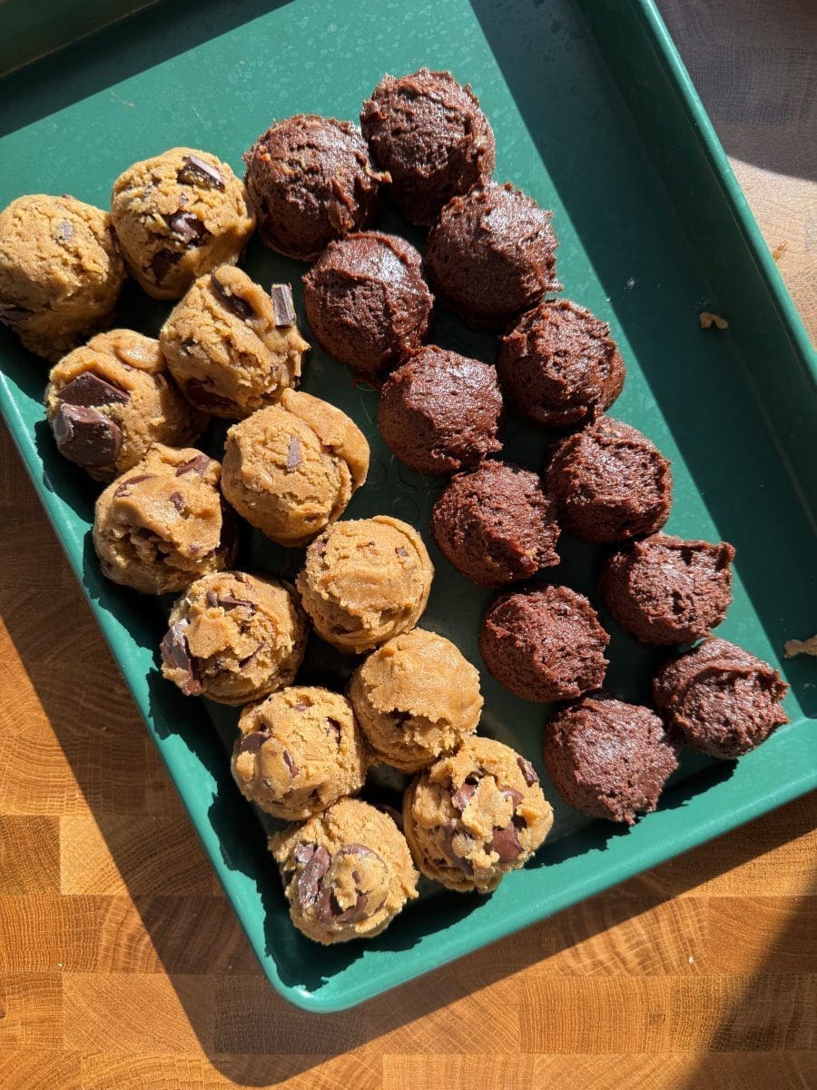 Both cookie doughs scooped out into balls on a tray.