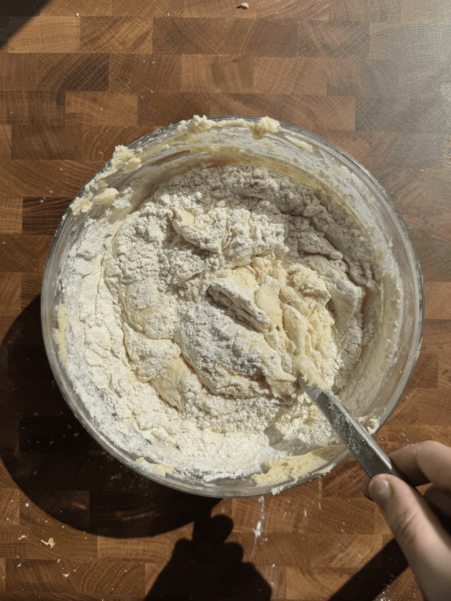 Folding flour into the batter.