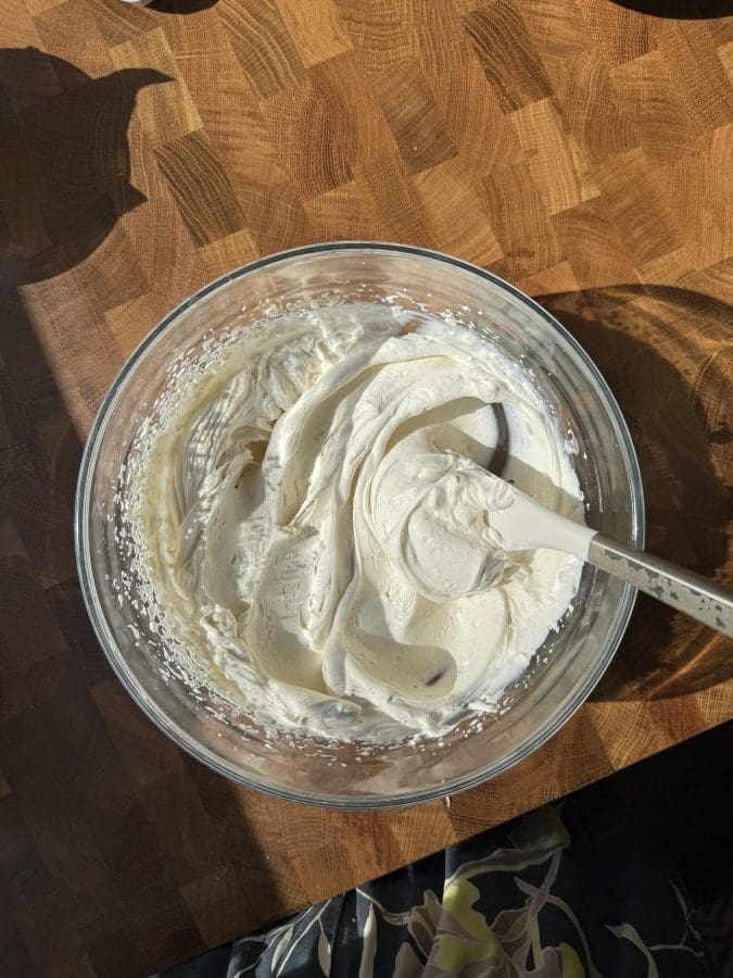 Mascarpone whipped cream in. a mixing bowl.