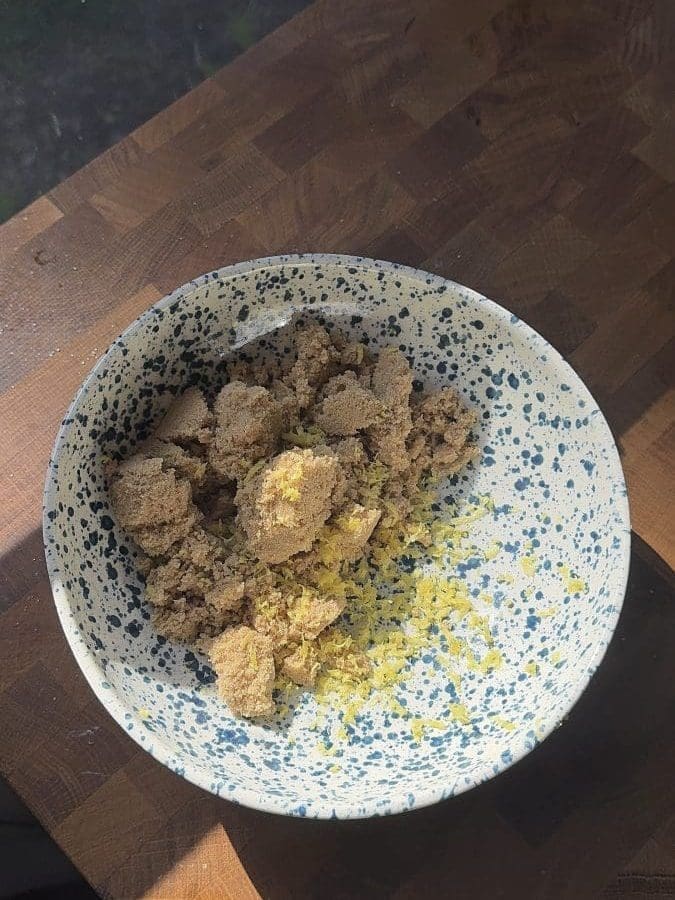 Lemon zest and brown sugar in a mixing bowl.