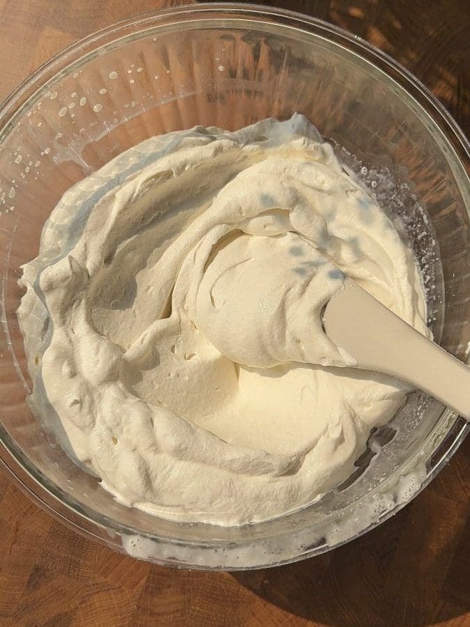 Whipped cream in a mixing bowl