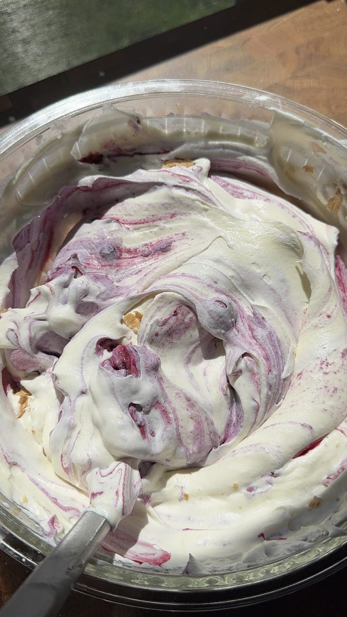 Folding the blueberries into the no-churn blueberry pie ice cream