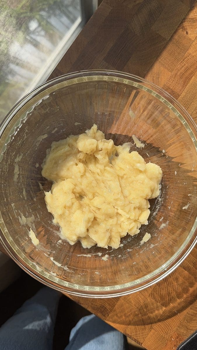 The bananas mashed in a large mixing bowl.