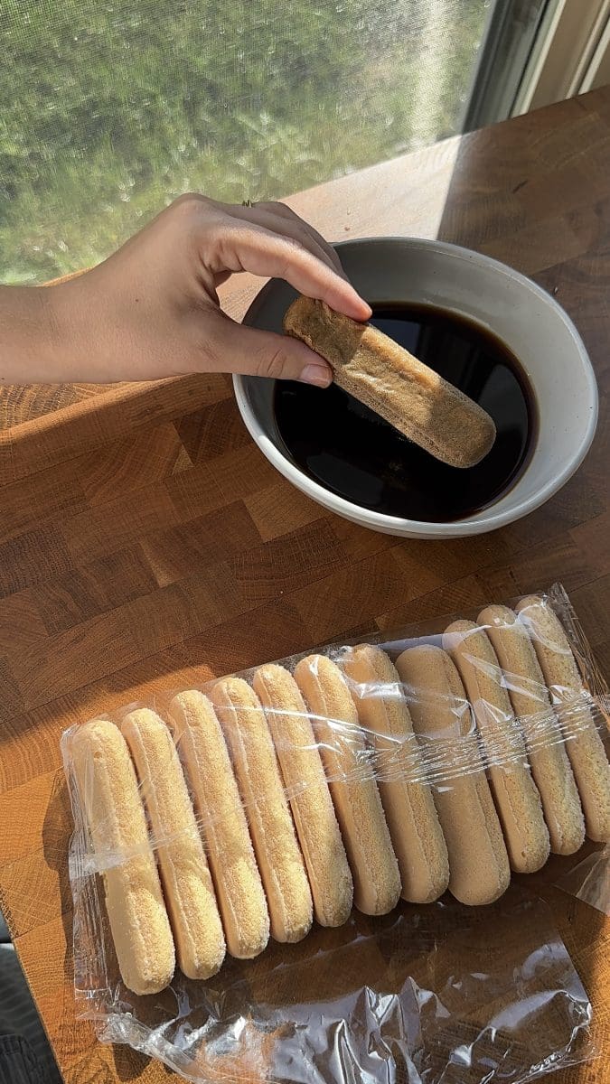 Dipping ladyfingers into the espresso soak.