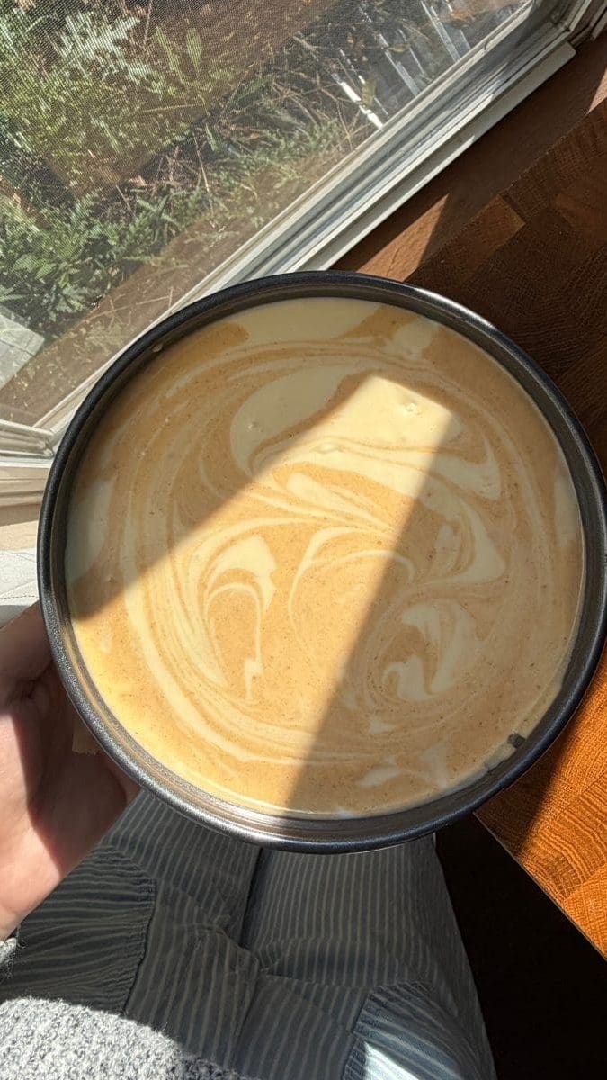 The pumpkin and vanilla cheesecake batters swirled in the springform pan.