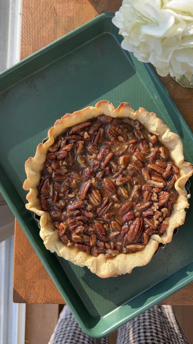 The maple pecan pie filling in the baked pie crust.