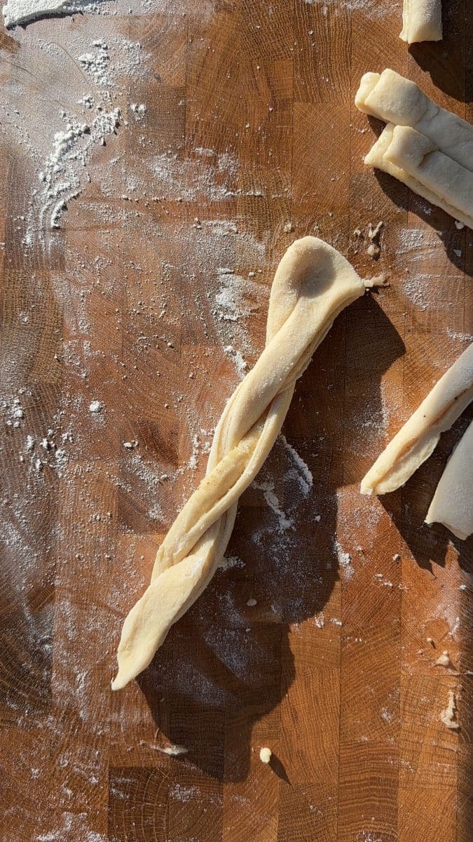 Twisting the strips of dough.