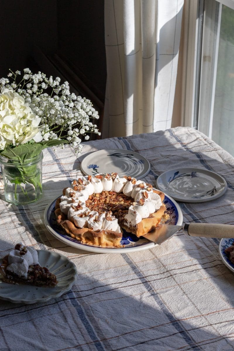 The maple pecan pie styled on a table.