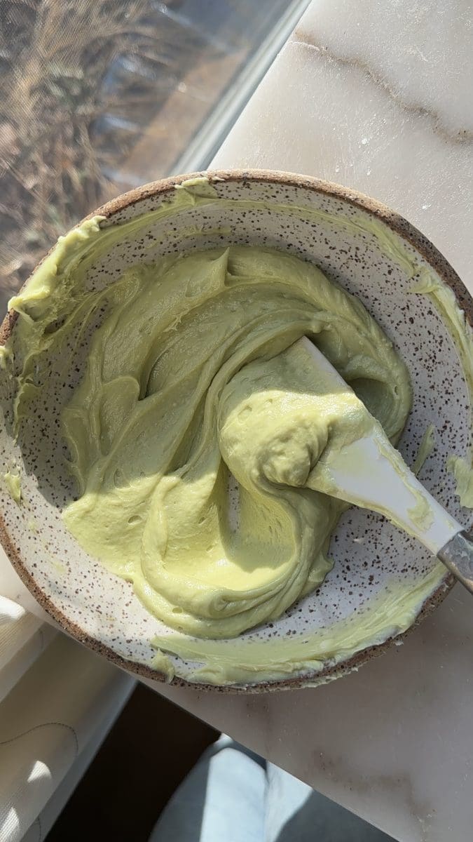 The pistachio cream cheese icing in a mixing bowl.