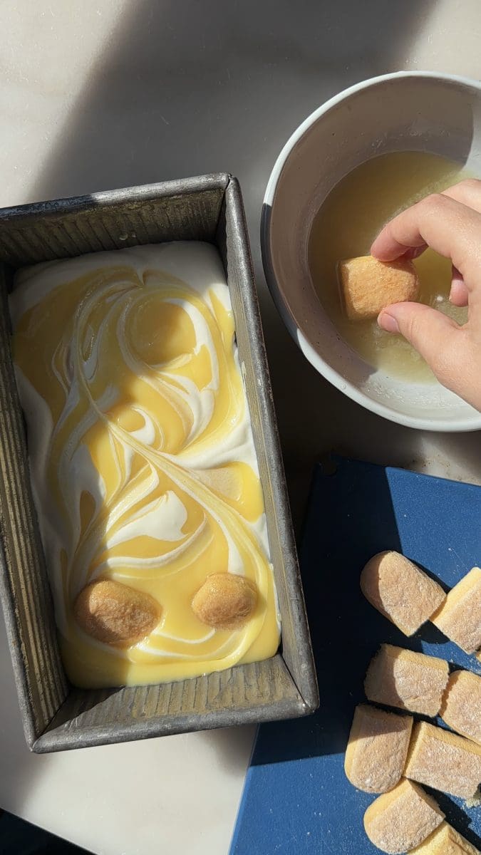 Layering the ice cream with lemon curd and lemon ladyfingers.