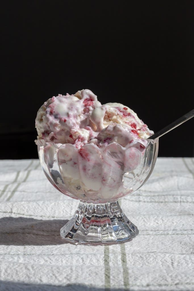 Berry chantilly cake ice cream scooped into a bowl